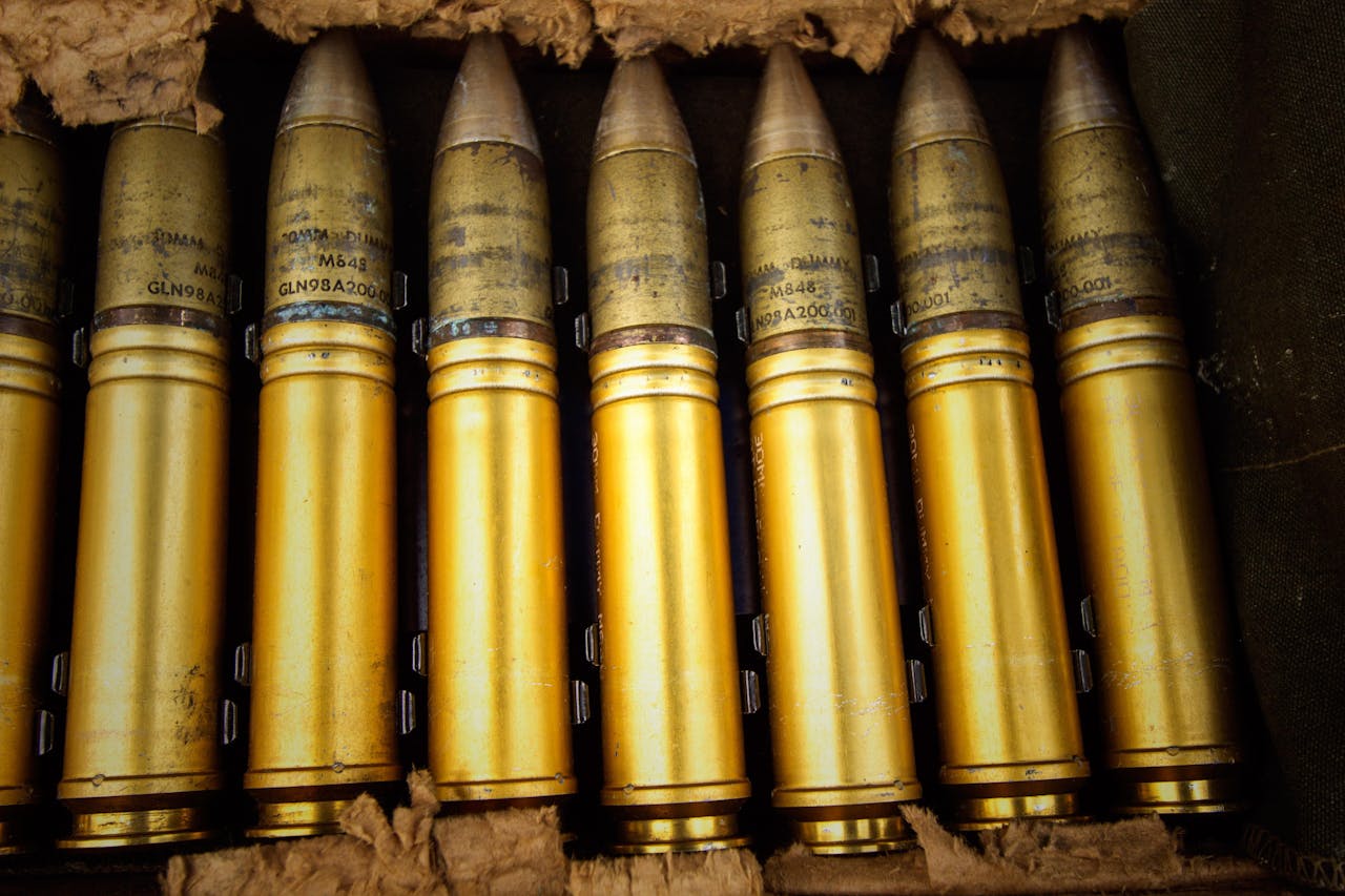 Detailed shot of brass ammunition in a military storage box.